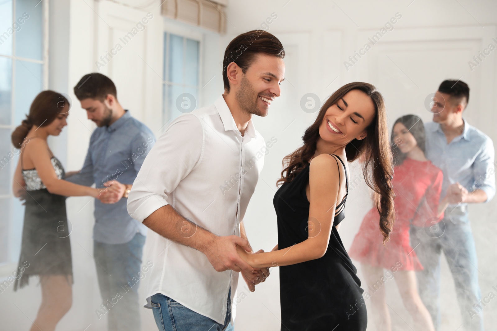 Photo of Lovely young couple dancing together at party