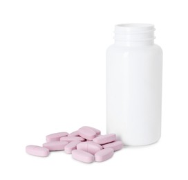 Photo of Bottle and pile of vitamin pills isolated on white