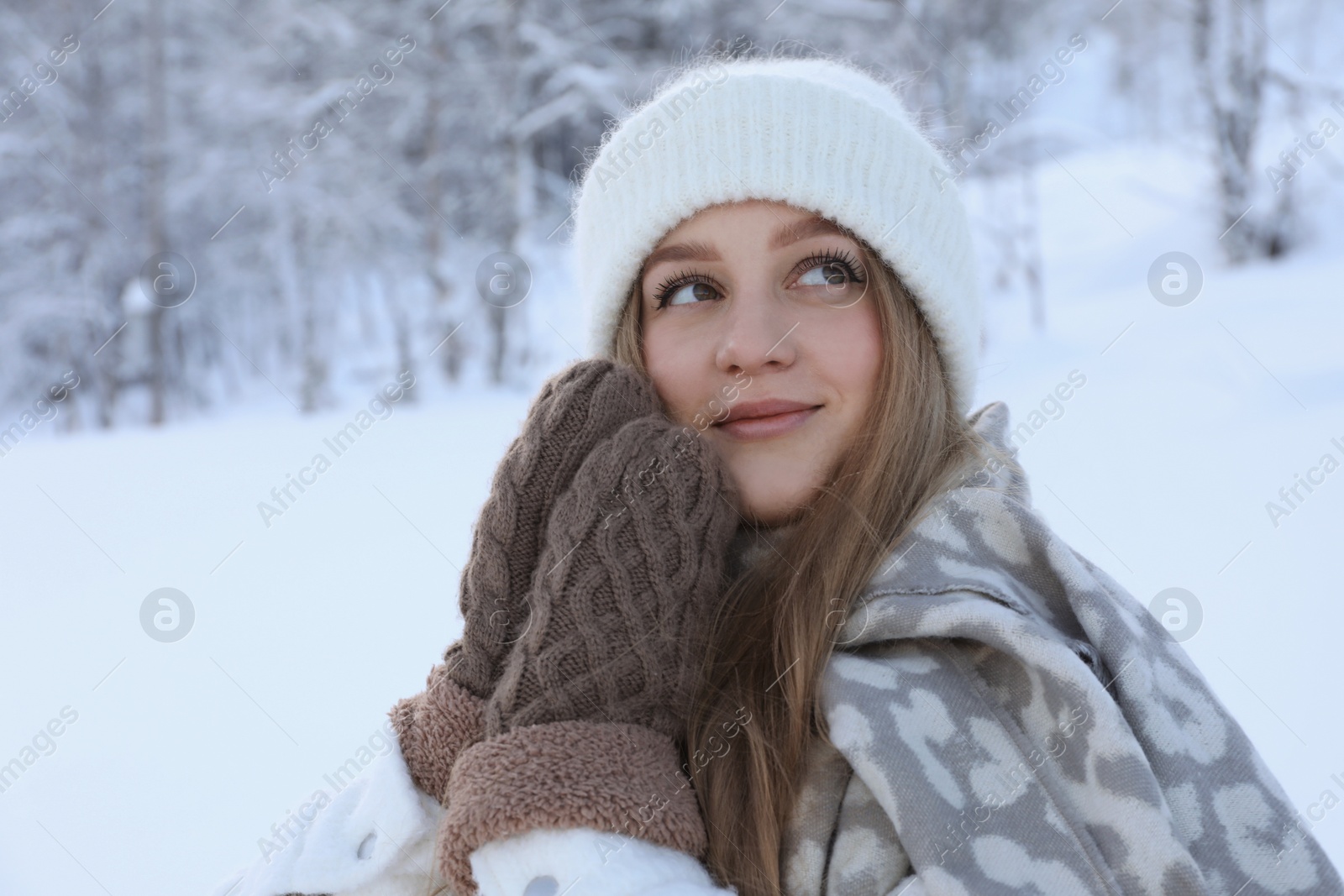 Photo of Winter vacation. Beautiful woman near snowy forest outdoors. Space for text