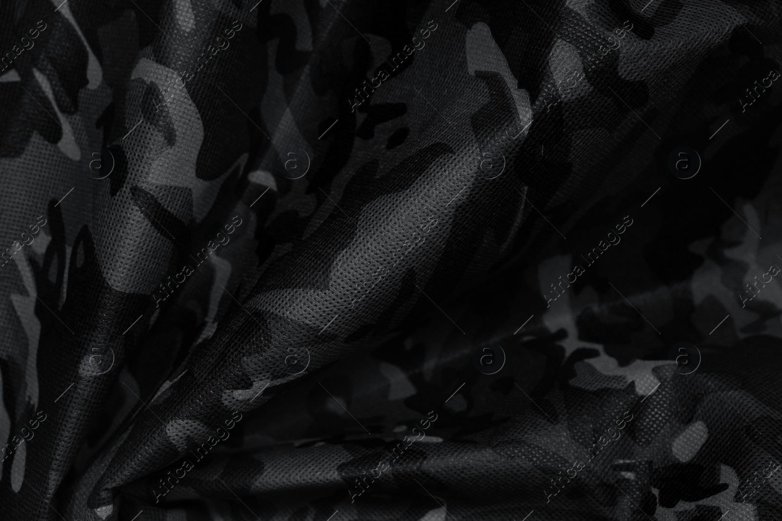 Image of Texture of crumpled camouflage fabric as background, top view. Black and white effect