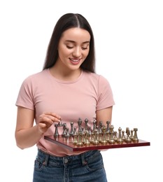 Photo of Happy woman holding chessboard and playing with game pieces on white background