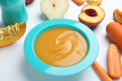 Healthy baby food and ingredients on white background, closeup