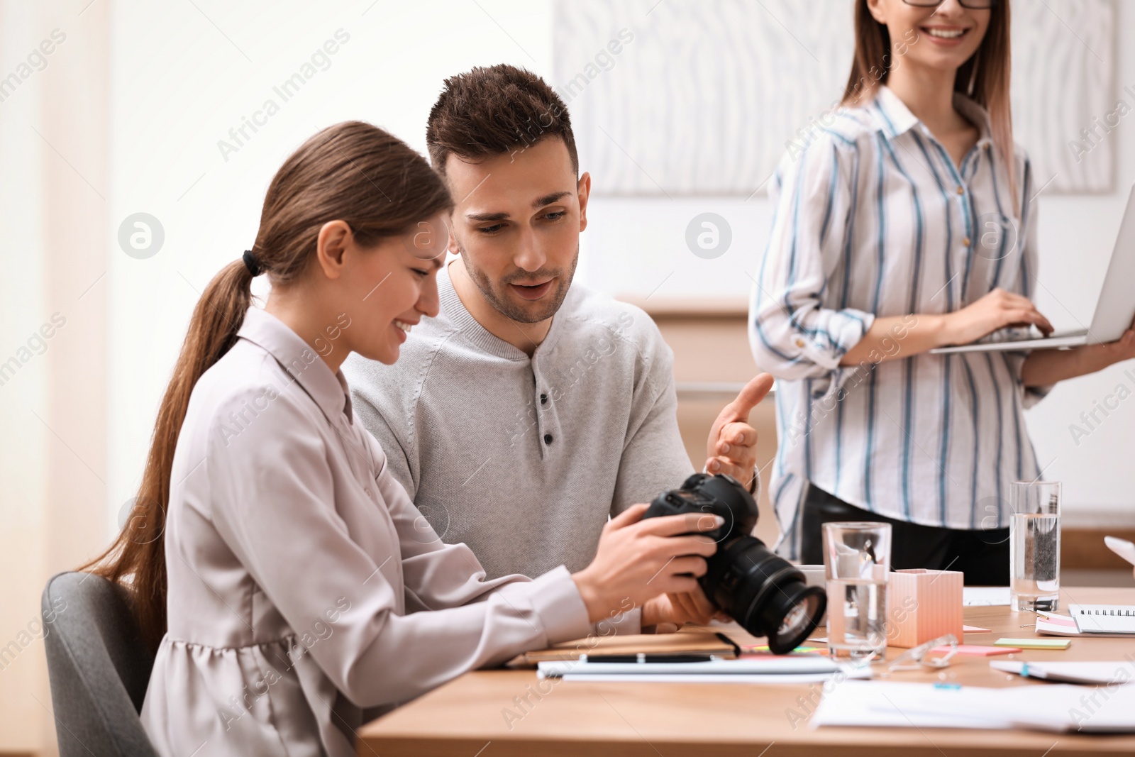 Photo of Team of professional journalists working in office