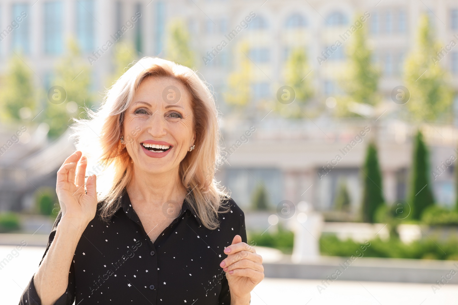 Photo of Portrait of happy mature woman on city street