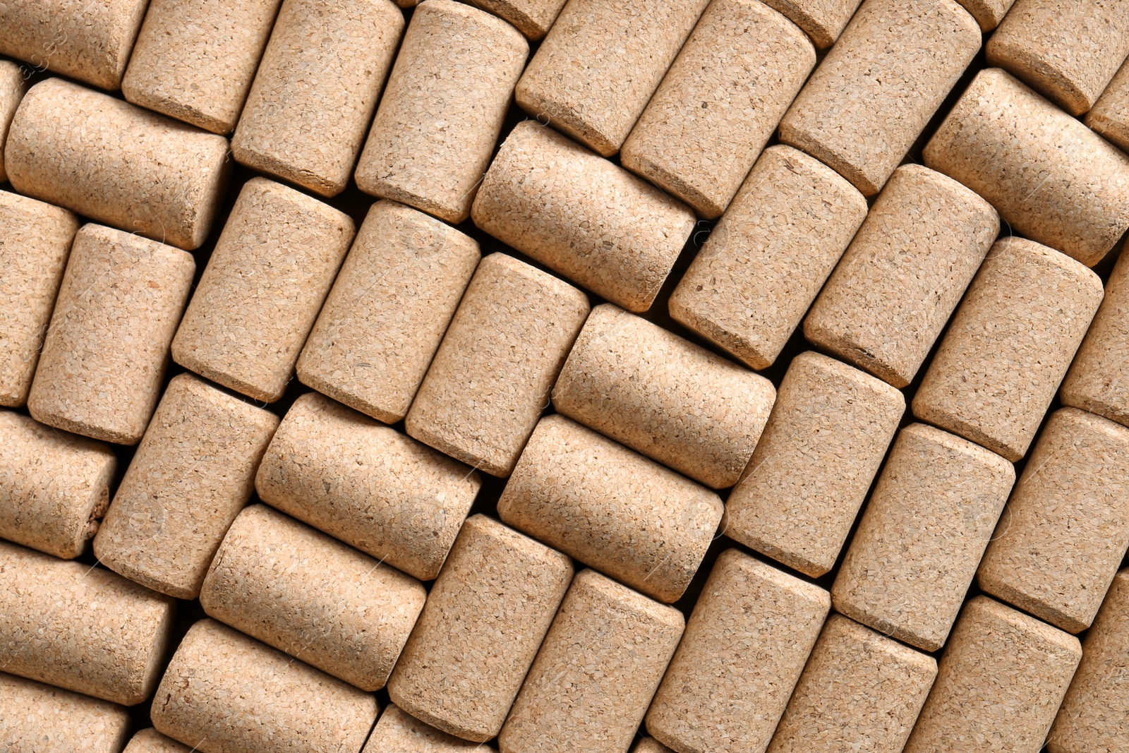 Photo of Many corks of wine bottles as background, top view