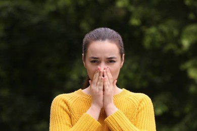 Photo of Woman suffering from seasonal spring allergy outdoors