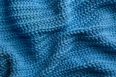 Beautiful light blue knitted fabric as background, top view
