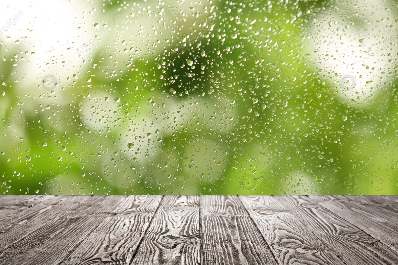 Image of Wooden table near window on rainy day