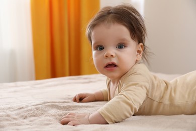 Photo of Portrait of cute little baby on bed indoors. Space for text