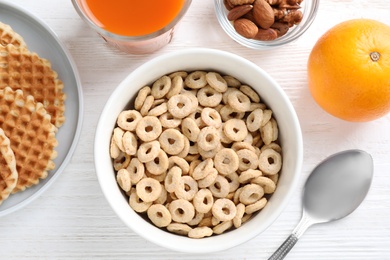 Photo of Flat lay composition with corn rings on white wooden table. Healthy breakfast