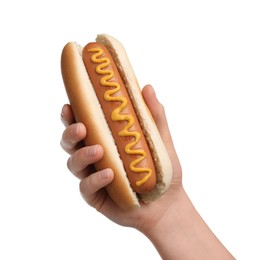 Woman holding delicious hot dog with mustard on white background, closeup