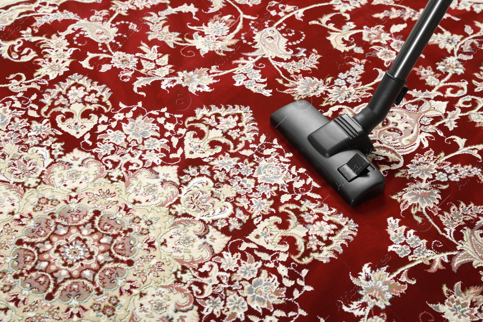 Photo of Removing dirt from carpet with modern vacuum cleaner. Space for text