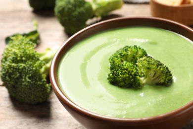 Fresh vegetable detox soup made broccoli in dish on table, closeup