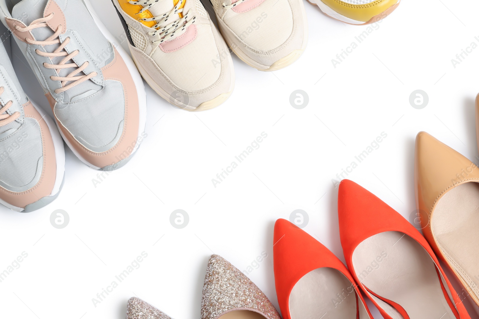 Photo of Frame of different shoes on white background, top view with space for text