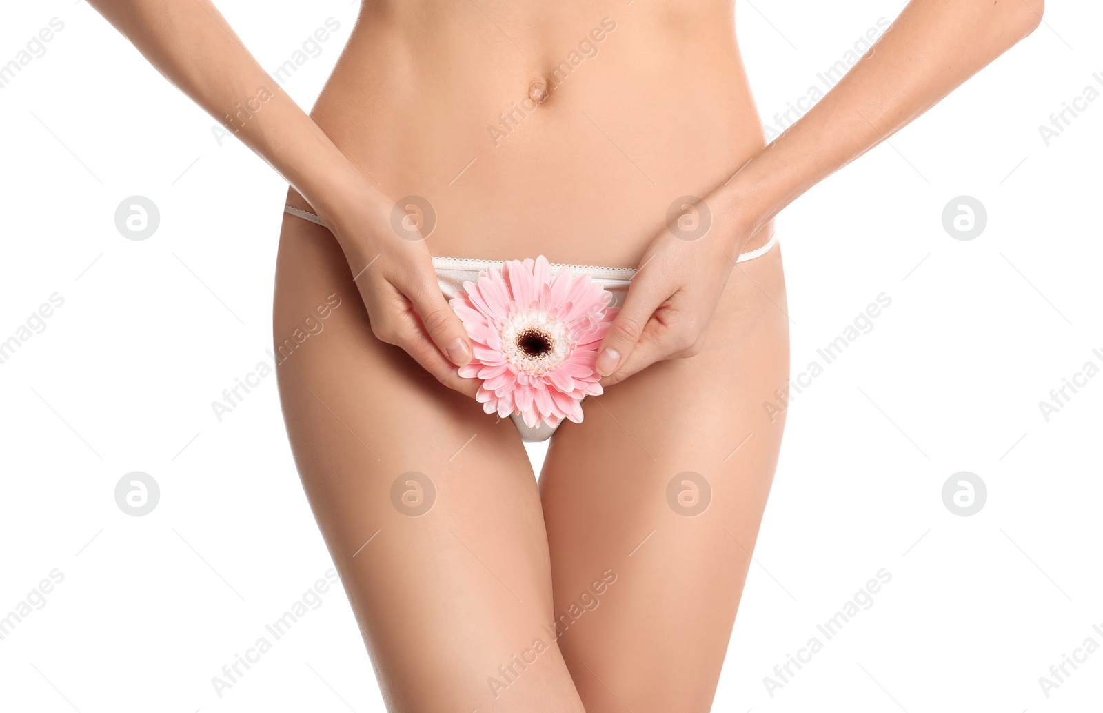 Photo of Woman with flower showing smooth skin after Brazilian bikini epilation on white background, closeup. Body care concept