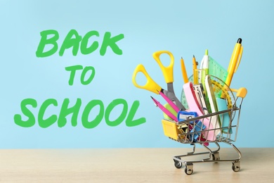 Image of Text Back To School and different stationery on light blue background