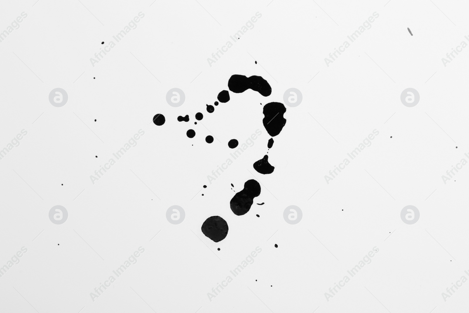 Photo of Blots of black ink on white background, top view