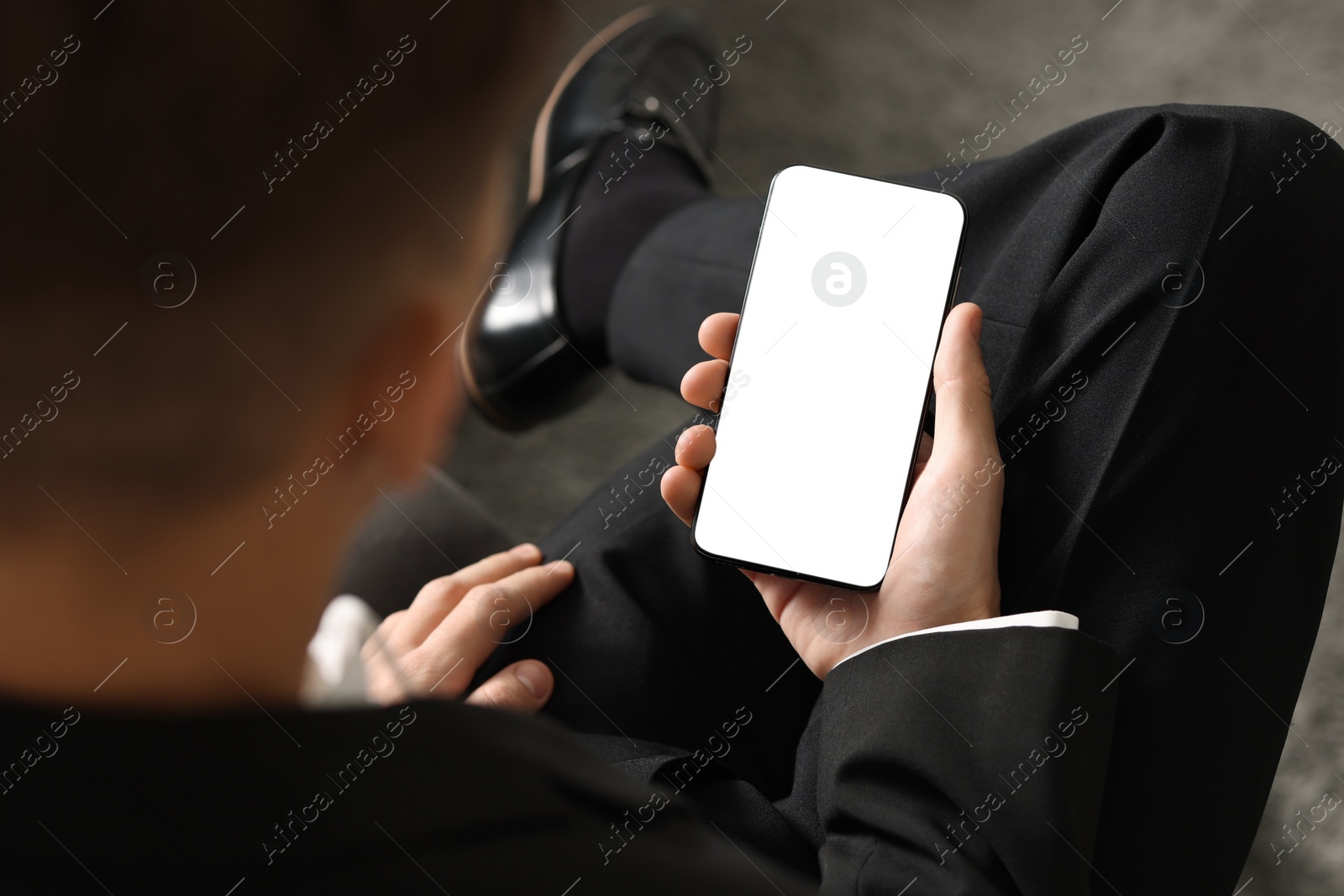 Photo of Man using smartphone with blank screen indoors, closeup. Mockup for design