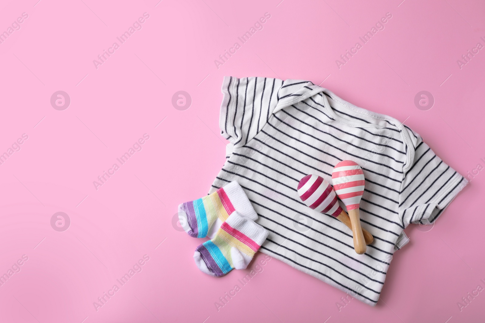 Photo of Stylish baby clothes and toys on color background, top view. Space for text