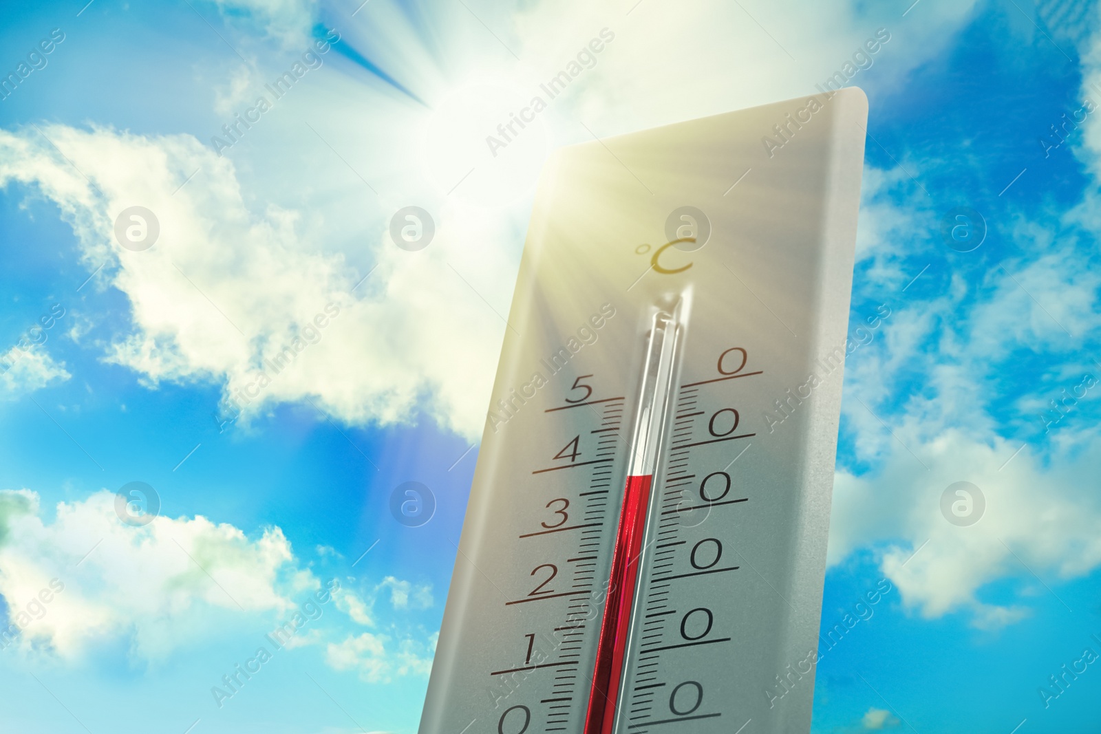 Image of Weather thermometer showing high temperature and blue sky with clouds on background