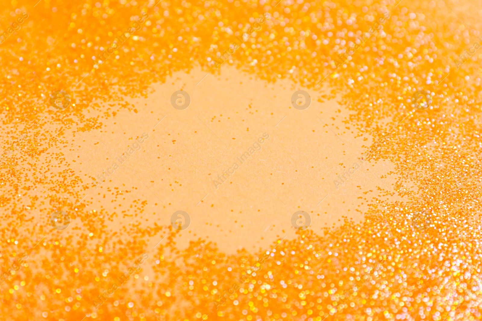 Photo of Frame made of shiny bright glitter on beige background, closeup. Space for text