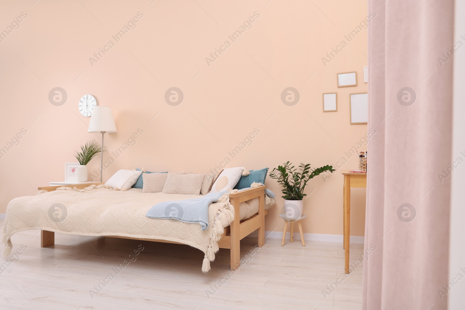 Photo of Cozy room interior with comfortable sofa bed. Multifunctional furniture