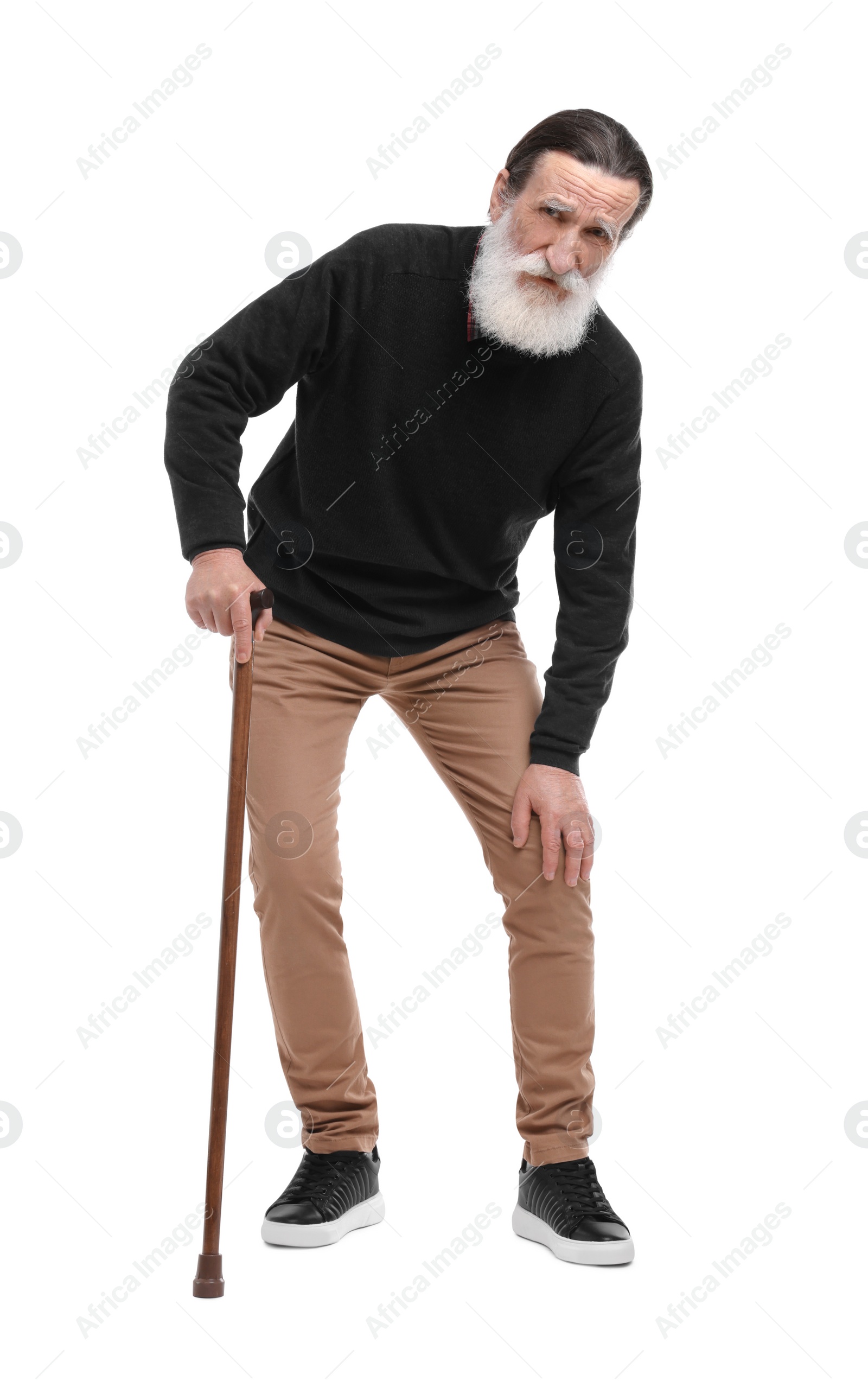 Photo of Senior man with walking cane suffering from knee pain on white background