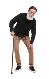 Senior man with walking cane suffering from knee pain on white background
