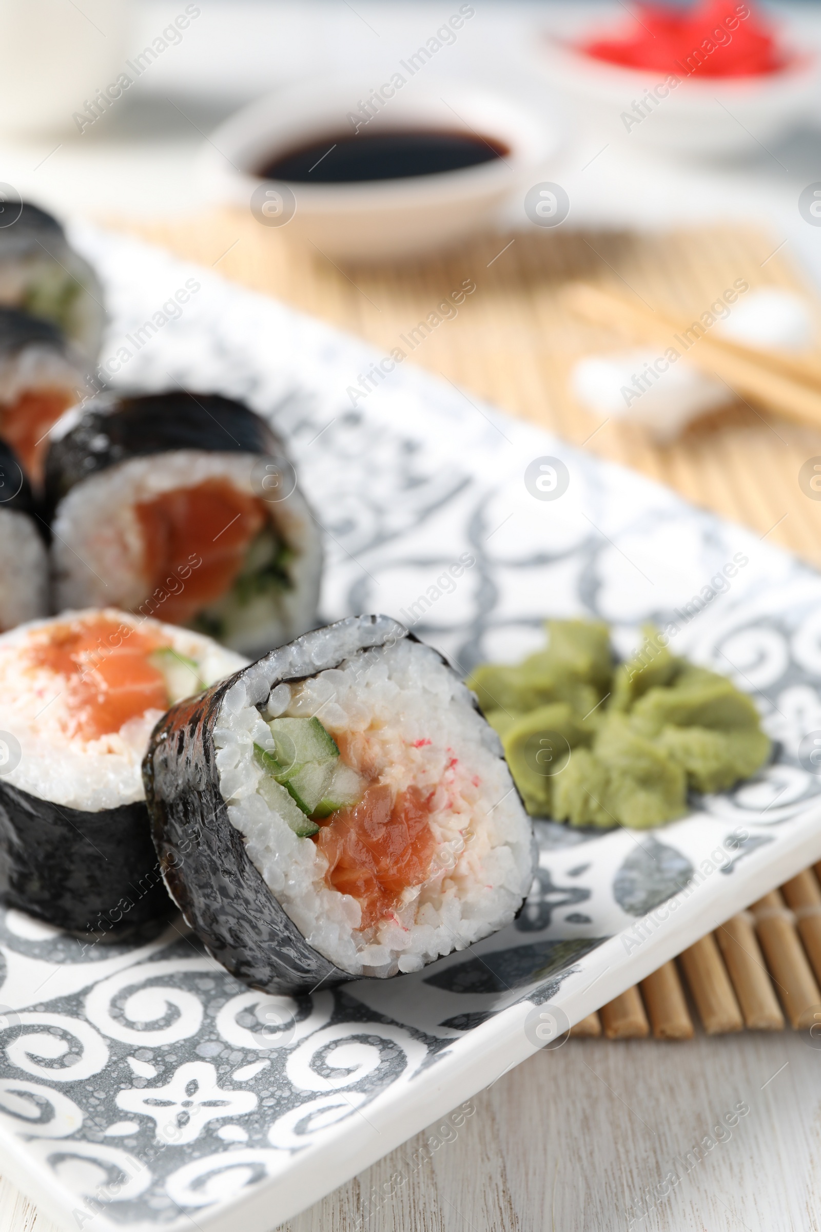 Photo of Tasty sushi rolls with wasabi served on table, closeup