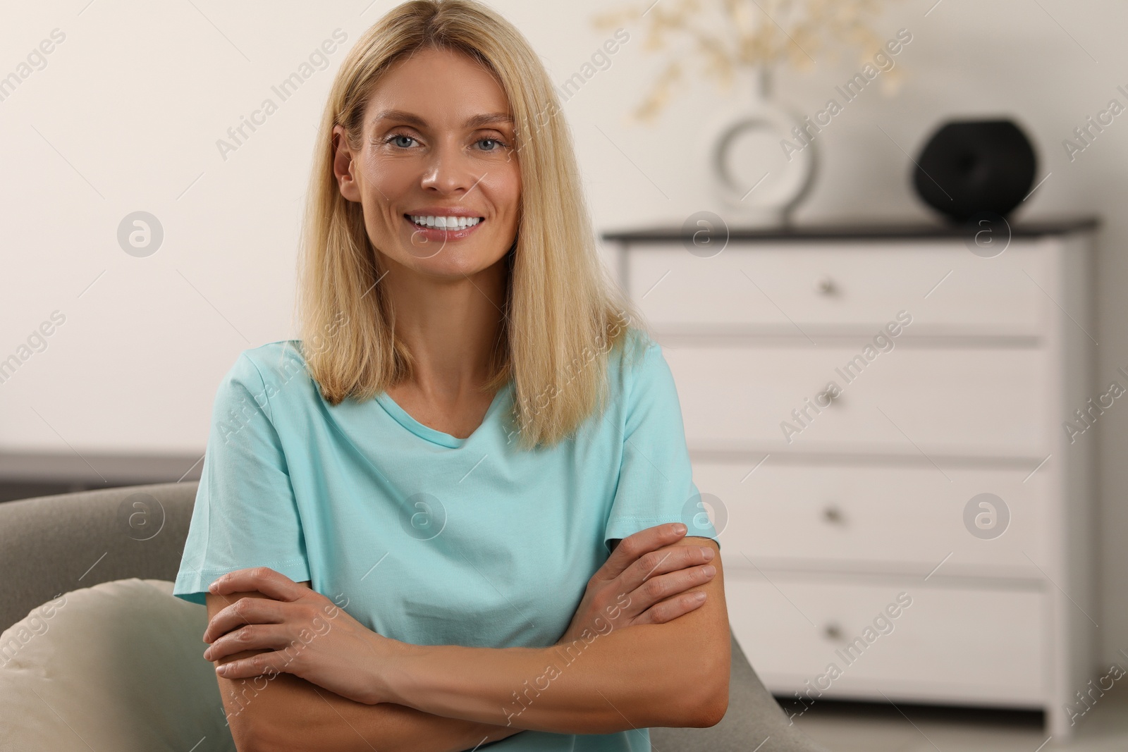 Photo of Portrait of beautiful woman with blonde hair. Attractive lady smiling and looking into camera. Space for text