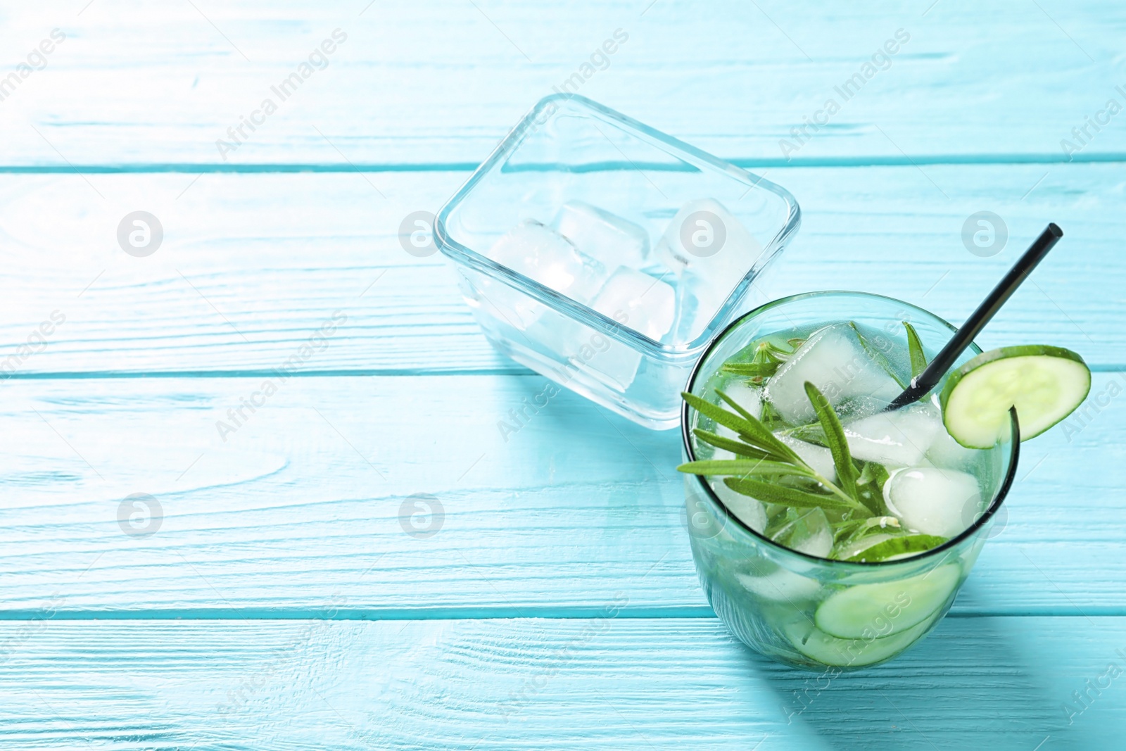 Photo of Natural lemonade with cucumber in glass on wooden table