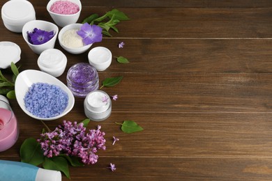 Photo of Homemade cosmetic products and fresh ingredients on wooden table. Space for text