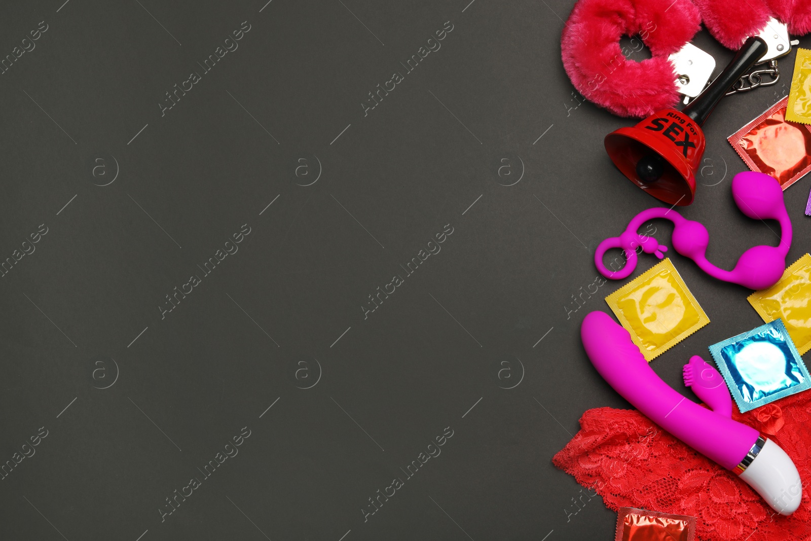 Photo of Different sex toys on black background, flat lay. Space for text