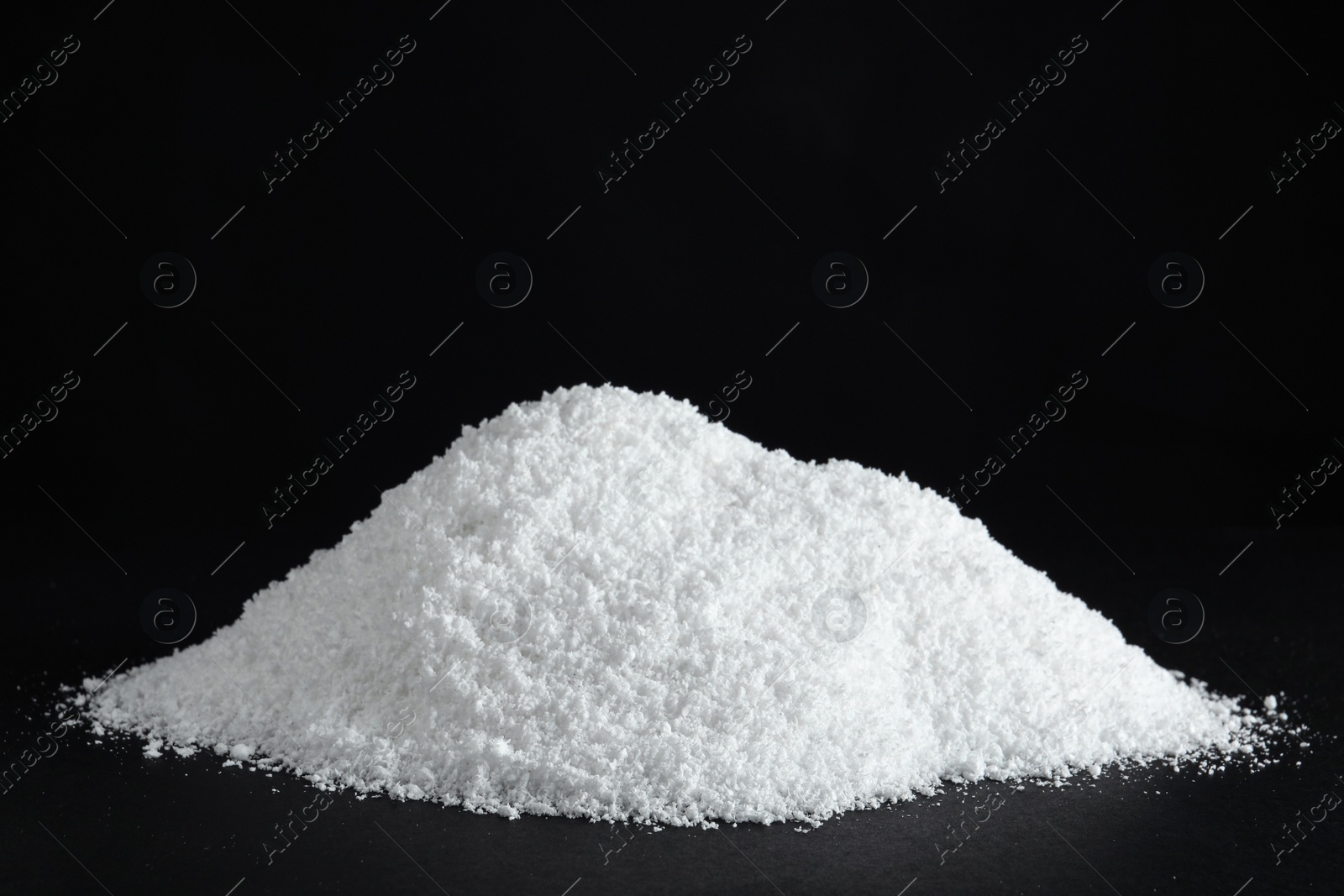 Photo of Heap of white snow on black background