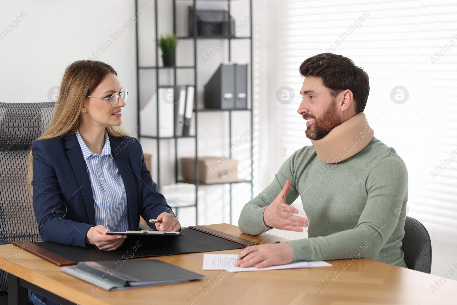 Photo of Injured man having meeting with lawyer in office