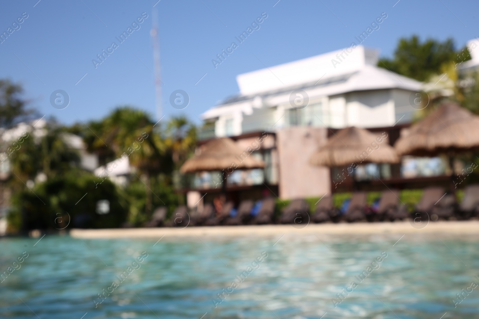 Photo of Blurred view of outdoor swimming pool at resort on sunny day