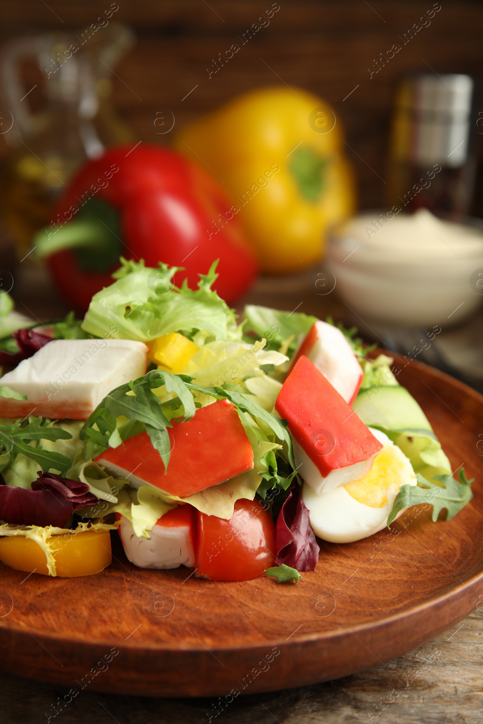 Photo of Delicious salad with crab sticks and lettuce on table, closeup