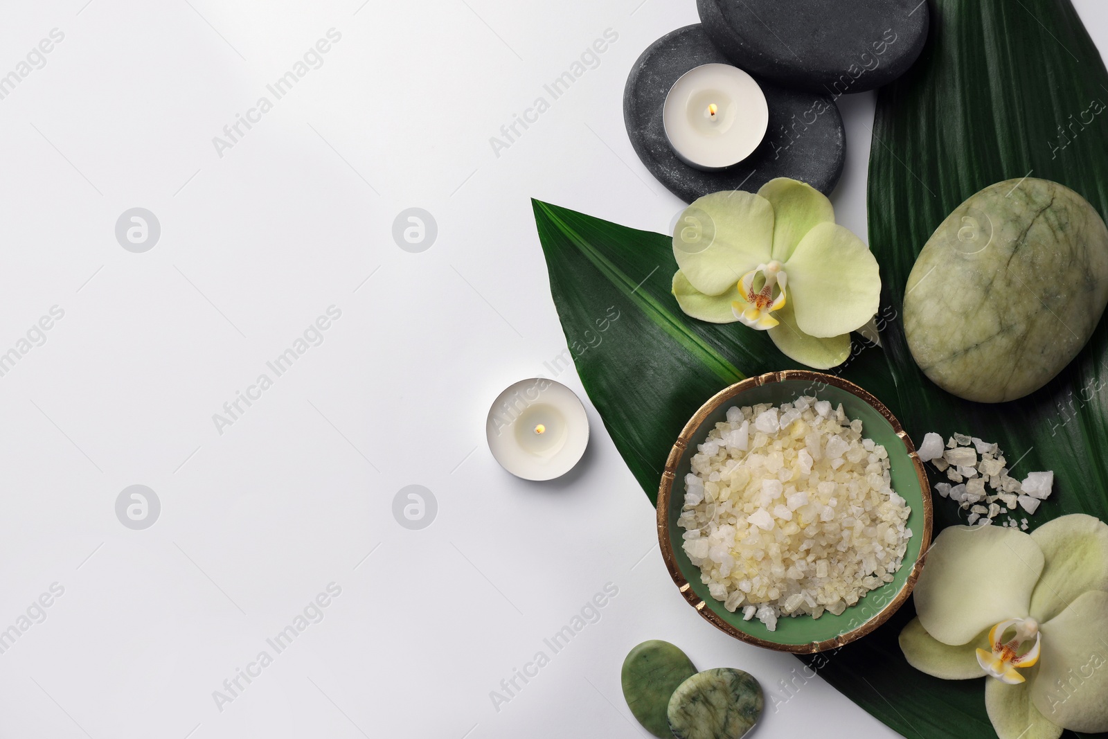 Photo of Flat lay composition with spa stones, sea salt and beautiful flowers on white table. Space for text