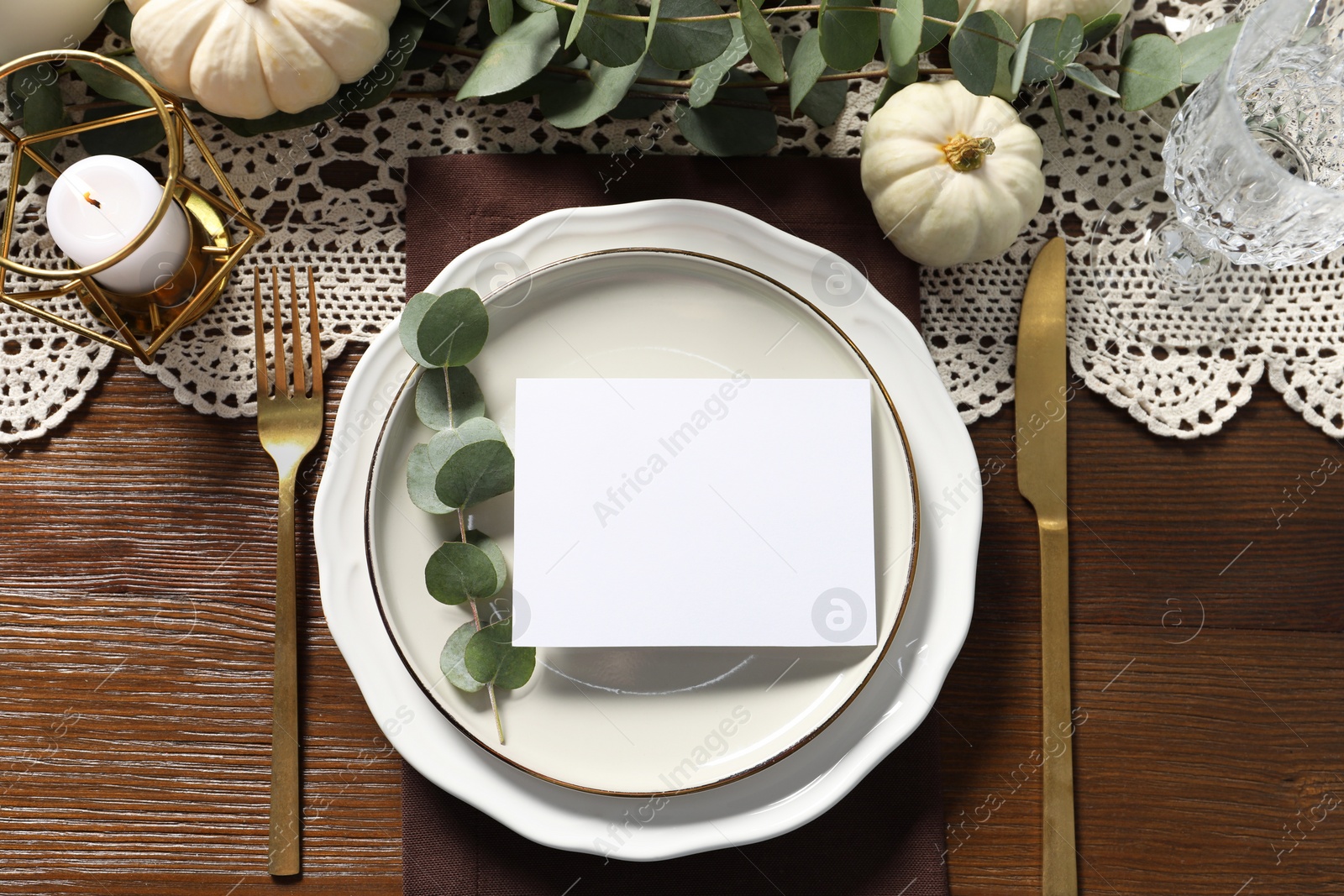 Photo of Beautiful autumn table setting with blank card and floral decor, flat lay