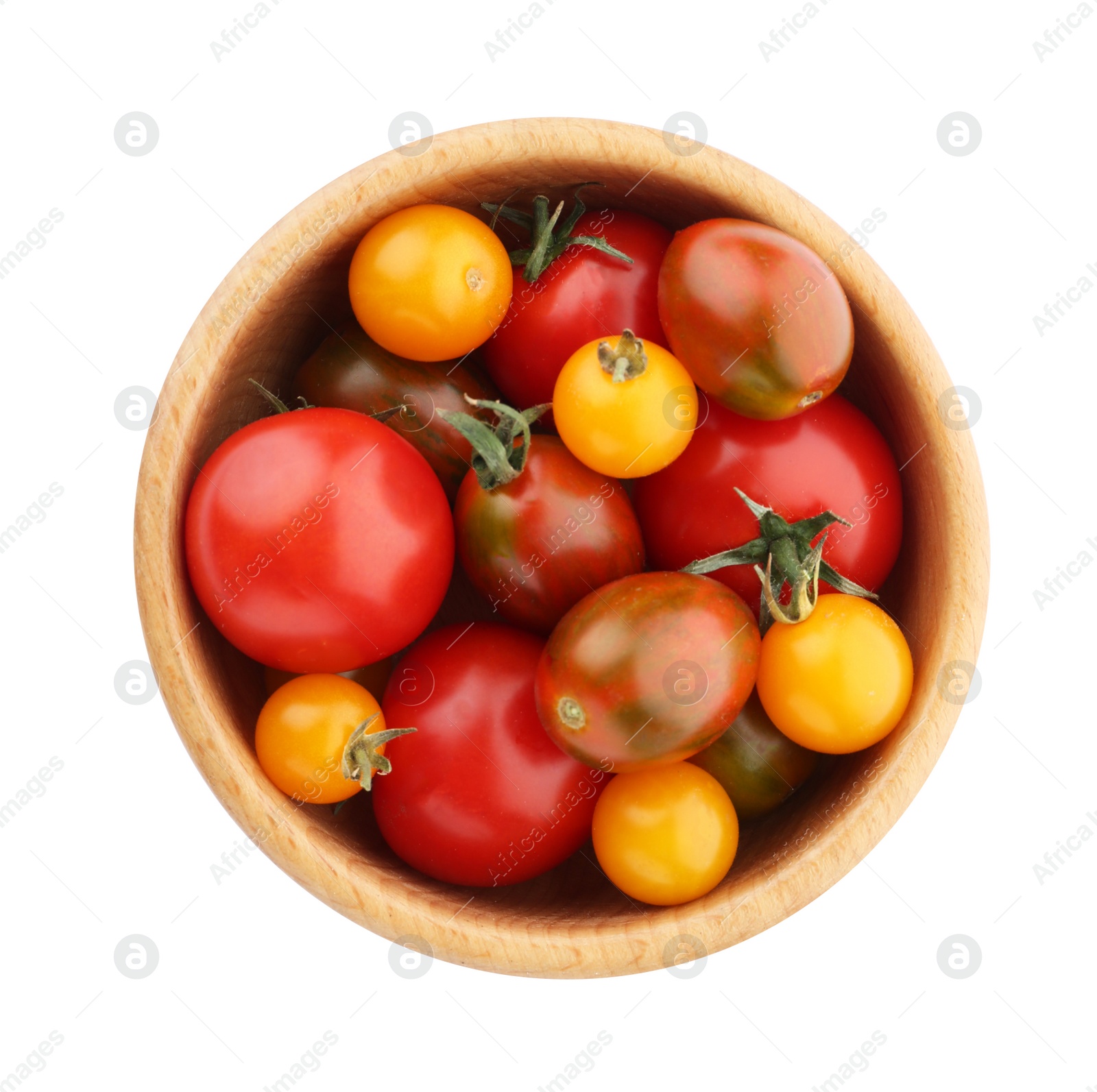 Photo of Ripe red and yellow tomatoes in wooden bowl on white background, top view