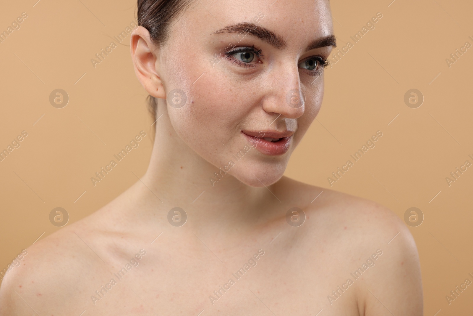 Photo of Portrait of beautiful woman on beige background, closeup