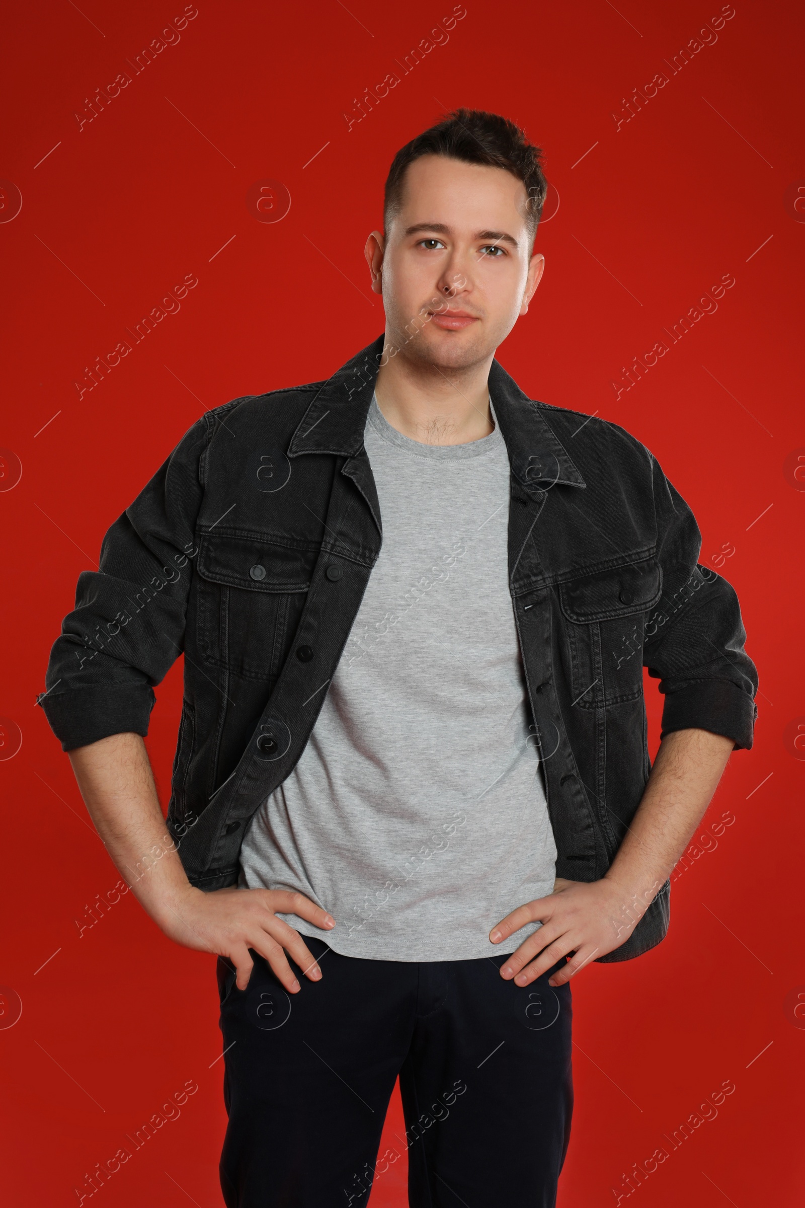 Photo of Portrait of young man on red background