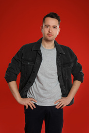 Portrait of young man on red background