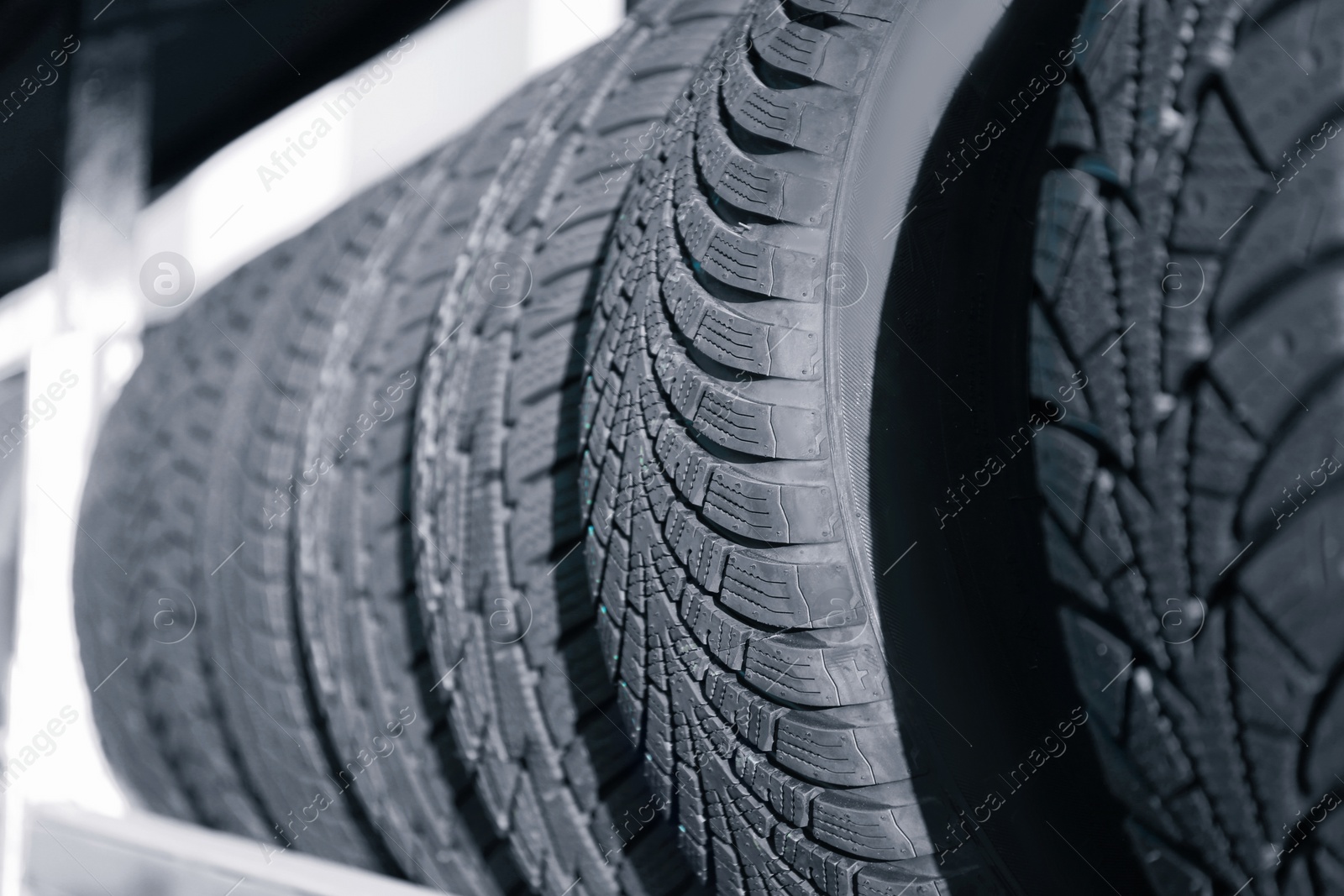 Photo of Tires on rack in car service workshop, closeup