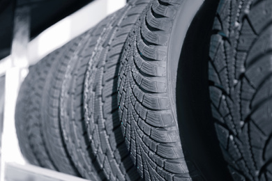 Tires on rack in car service workshop, closeup