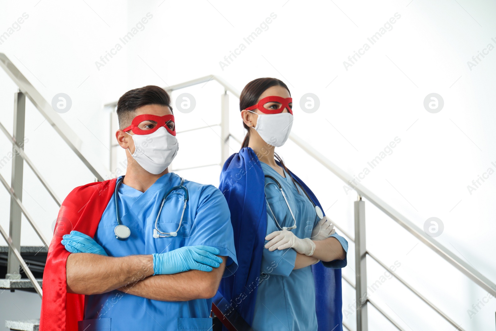 Photo of Doctors dressed as superhero in hospital. Concept of medical workers fighting with COVID-19