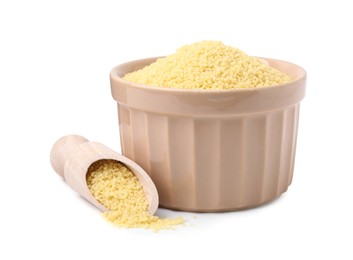 Bowl and scoop with raw couscous on white background