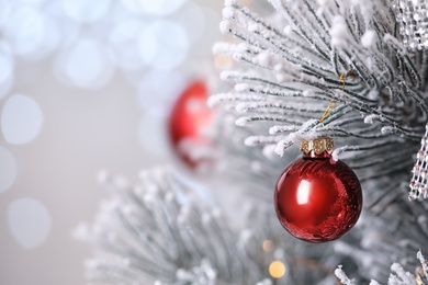 Beautiful Christmas tree with festive decor against blurred lights on background, closeup. Space for text