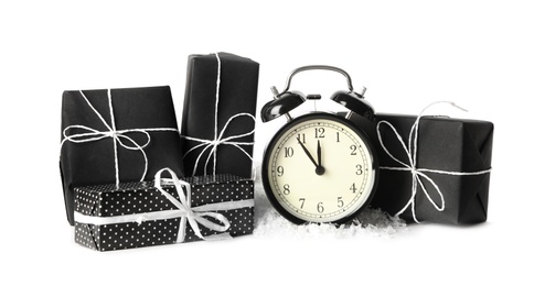 Alarm clock and gifts on white background. New Year countdown