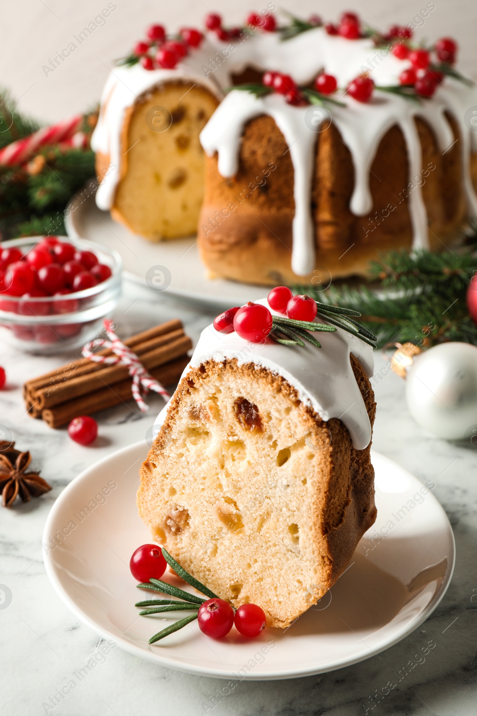 Photo of Composition with piece of traditional homemade Christmas cake on white marble table, closeup